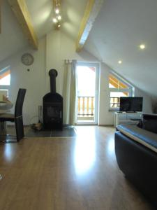 ein Wohnzimmer mit Kamin und Couch in der Unterkunft Wacholder am Waldsee 2 in Rieden