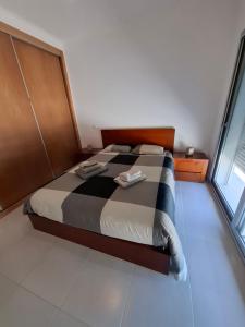 a bedroom with a bed with two towels on it at G at Bela Baia Salir in Salir de Porto +20 photos