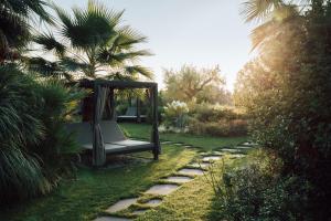 a swing in the middle of a garden at Conti Thun Wine Resort in Puegnano del Garda +32 photos