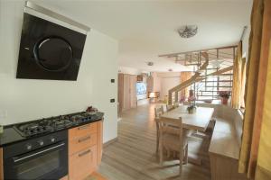 a kitchen and dining room with a stove and a table at CAMPIGLIO Panorama sul Brenta in Madonna di Campiglio +47 photos