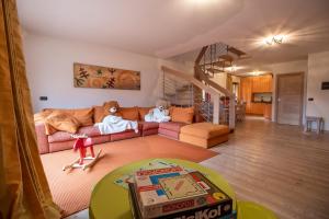 two teddy bears sitting on a couch in a living room at CAMPIGLIO Panorama sul Brenta in Madonna di Campiglio
