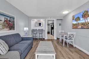 a living room with a couch and a table at Boardwalk Resort 233 in Myrtle Beach +24 photos