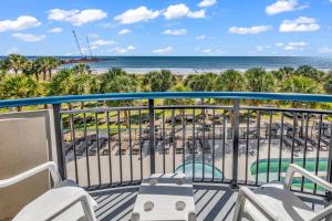 a balcony with chairs and a view of the beach at Boardwalk Resort 233 in Myrtle Beach