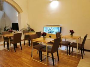 a dining room with tables and chairs and a fish tank at Salentini house in Lecce