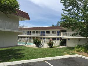 a large building with a pool in front of it at Motel 6-Yreka, CA in Yreka