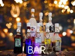 a group of bottles of alcohol sitting on a table at Arigato Stay Kanazawa Katamachi in Kanazawa