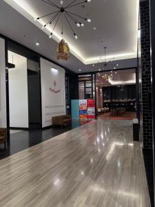 a lobby with a wooden floor and a chandelier at Chambers Suites Kuala Lumpur by AFA in Kuala Lumpur +54 photos