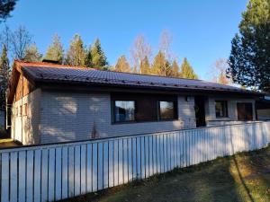 a house with a fence in front of it at NorthSlope in Rovaniemi