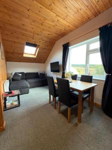 a living room with a table and a couch at Glenariff Forest Hideaway in Glenariff