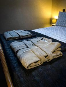 a pile of folded towels sitting on a bed at Glenariff Forest Hideaway in Glenariff