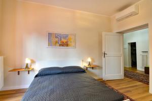a bedroom with a bed and two lights on the wall at Residenza La Donzella - Appartamento rosso in Campobasso +8 photos