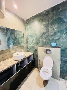 a bathroom with a toilet and a sink at Block K in New Delhi