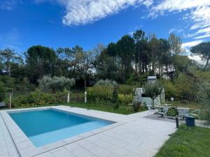 a swimming pool in a yard with a patio at Acquavilla in Pombal