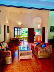 a living room with two couches and a table at Sana Villa & Resort Anjuna Beach Goa in Anjuna