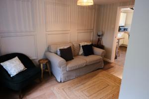 a living room with a couch and a chair at The Granary Cottages 