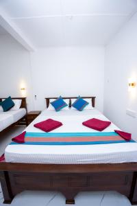 Ένα ή περισσότερα κρεβάτια σε δωμάτιο στο Sigiri Star Homestay