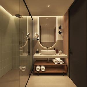 une salle de bain avec un lavabo et un miroir dans l'établissement Hotel Trianon, à Bucarest