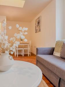 a living room with a couch and a table at 58b Thorpe Road - City Centre in Norwich