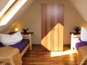 a room with two beds and a wooden door at Holiday Home Am See I by Interhome in Verchen