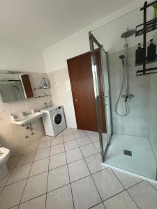 a bathroom with a shower and a washing machine at la iaia's home in Rozzano +37 photos