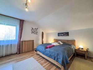 a bedroom with a bed and a large window at Apartment Ferienwohnung Monika by Interhome in Öblarn
