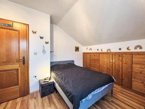 a bedroom with a bed and a wooden cabinet at Apartment Ferienwohnung Monika by Interhome in Öblarn