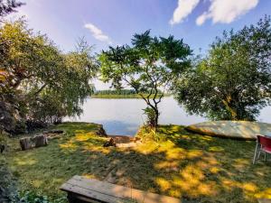 un bateau assis sur l'herbe à côté d'un lac dans l'établissement Holiday Home Pondside Retreat & Canoe by Interhome, à Holubovská Bašta