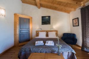 a bedroom with a bed and a blue chair at Les Nuits du Taris in Bourdeaux +56 photos