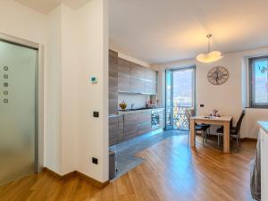 a kitchen and dining area with a table and a dining room at Apartment Blue Lake by Interhome in Bellano +24 photos