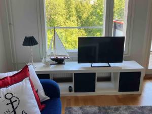 a living room with a tv sitting on a table at Beautiful studio with sauna, balcony in Rauma