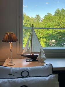 a toy boat on a table next to a window at Beautiful studio with sauna, balcony in Rauma