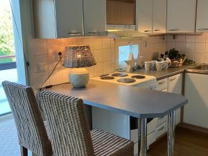 a kitchen with a table with a lamp on it at Beautiful studio with sauna, balcony in Rauma
