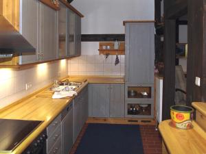 a kitchen with gray cabinets and a sink at Deelenwohnung in Trebel