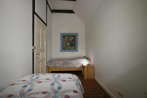 a small bedroom with a bed and a small table at Deelenwohnung in Trebel +33 photos