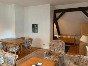 a living room with a table and chairs at Schwalbennest in Trebel