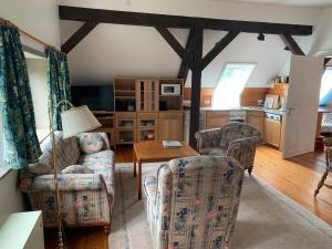 a living room with two chairs and a table at Schwalbennest in Trebel