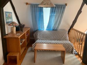 a room with a chair and a table and a window at Schwalbennest in Trebel