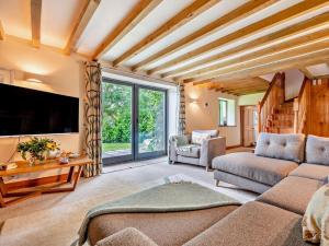 a living room with a couch and a tv at 2 Bed in Bude 64088 in Marhamchurch