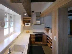 a kitchen with a sink and a stove top oven at Teichblick in Trebel