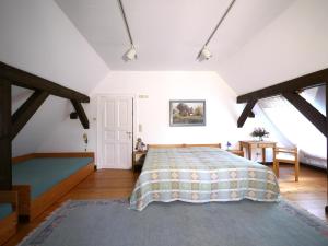 a large bedroom with a bed and a table at Teichblick in Trebel
