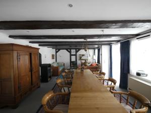 a long wooden table in a room with chairs at Teichblick in Trebel