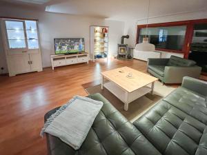 a living room with a couch and a table at Ferienhaus Heideweg in Zingst +25 photos