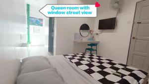 a bedroom with a bed with a checkered floor at MUSANG ONG HOTEL in Cameron Highlands +12 photos