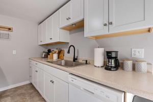 a kitchen with white cabinets and a sink at Post & Beam - SHARED 4 Bedroom 1 Bath Home On Pond - Shared 4 Bedrooms Available in Bradford