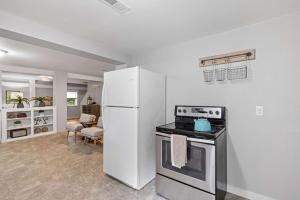 a kitchen with a white refrigerator and a stove at Post & Beam - SHARED 4 Bedroom 1 Bath Home On Pond - Shared 4 Bedrooms Available in Bradford