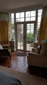 a living room with a large glass door at The Oasis in Bridlington