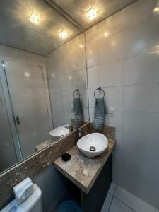 a bathroom with a sink and a mirror at Aconchego in Porto Belo +30 photos