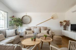 a living room with a couch and a table at Mas de l'Aranyó - Eco Wellness Spa in Hostafranco