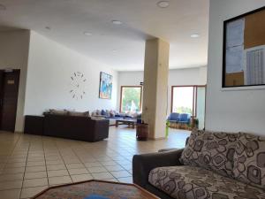 a living room with a couch and a table at Cabo dream in Cabo Negro