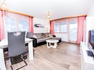 a living room with a couch and a table at Apartment Metropol B by Interhome in Grächen +3 photos